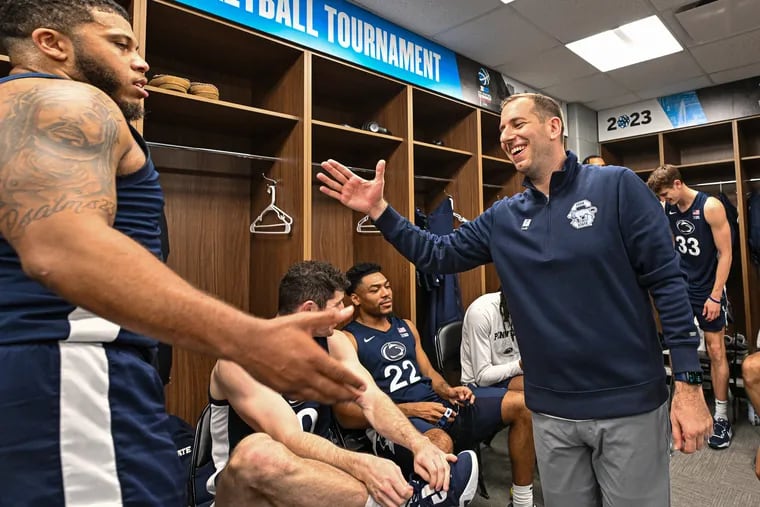 Penn State associate head coach Adam Fisher celebrates in the locker room after defeating Northwestern. A gritty team effort led Nittany Lions to a 67-65 overtime victory over second-seeded Northwestern in the Big Ten Tournament quarterfinals.