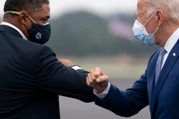 Joe Biden greeted Rep. Cedric Richmond, D-La., left, as he arrived at Columbus Airport in Columbus, Ga., on Oct. 27.