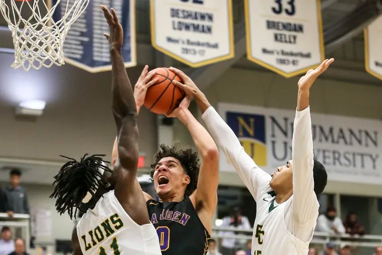 Camden's Lance Ware tries to shot over Roselle Catholic's Cliff Omoyuri (11) and Joshua Rivera tries to block the shot during the 1st quarter at Neumann University in Aston, Pa.,   Thursday,  January 23, 2020.