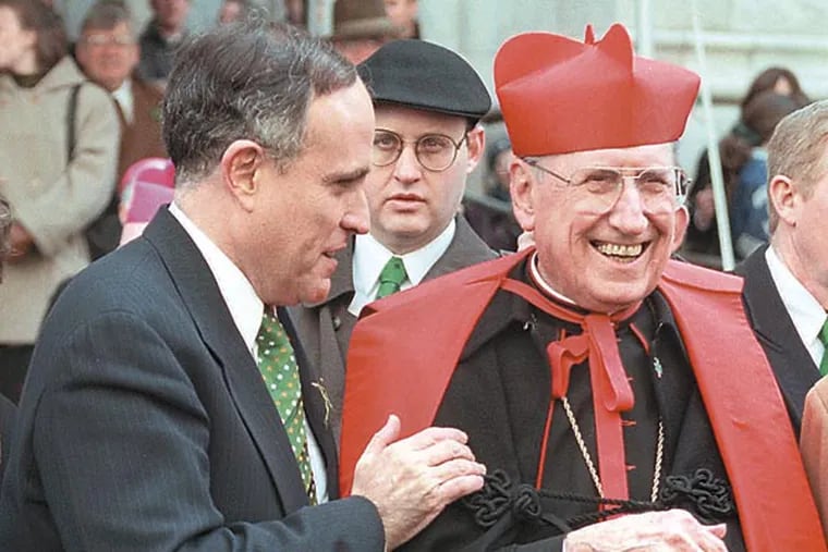 New York City Mayor Rudolph Giuliani greets Cardinal John O'Connor on the steps of New York's St. Patrick's Cathedral during the St. Patrick's Day Parade Monday, March 17, 1997. (AP Photo/Richard Drew/File)