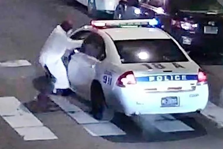 A still image from surveillance video shows a gunman approaching a Philadelphia Police cruiser in which Officer Jesse Hartnett was shot on January 8, 2016. Photo: Philadelphia Police Department