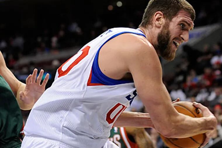 Spencer Hawes is averaging 9.2 points per game and leading the Sixers in rebounding and blocks. (Michael Perez/AP)