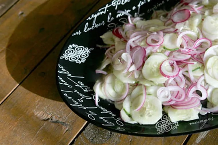A Cucumber Salad, above, adapted by chef Chris Koch from an 1876 cookbook. (CHARLES FOX / Staff Photographer)