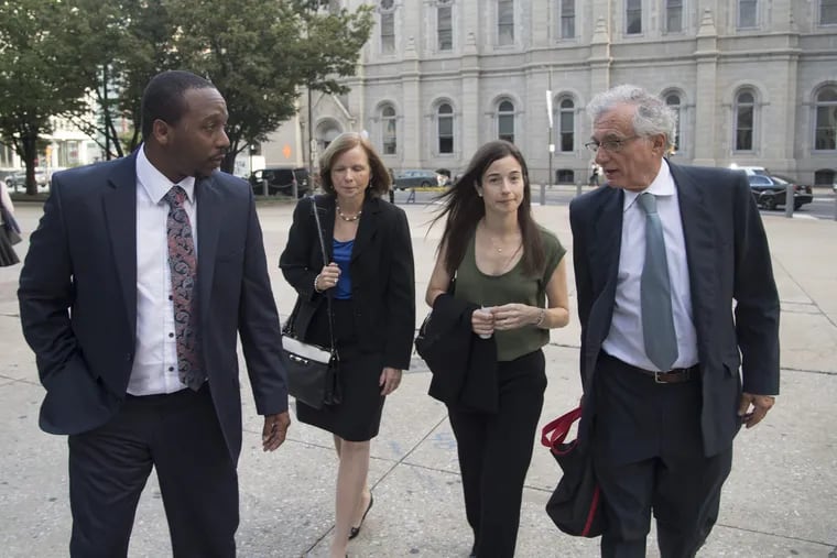 Plaintiff Bryant Miller (left) walks into Philadelphia City Hall September 13, 2016 with lawyers who would be arguing in front of the Pennsylvania Supreme Court for better school funding in Pennsylvania. The lawyers are Maura McInerney of the Education Law Center, Deborah Gordon Klehr, executive director of the Education Law Center, and Michael Churchill of the Public Interest Law Center.