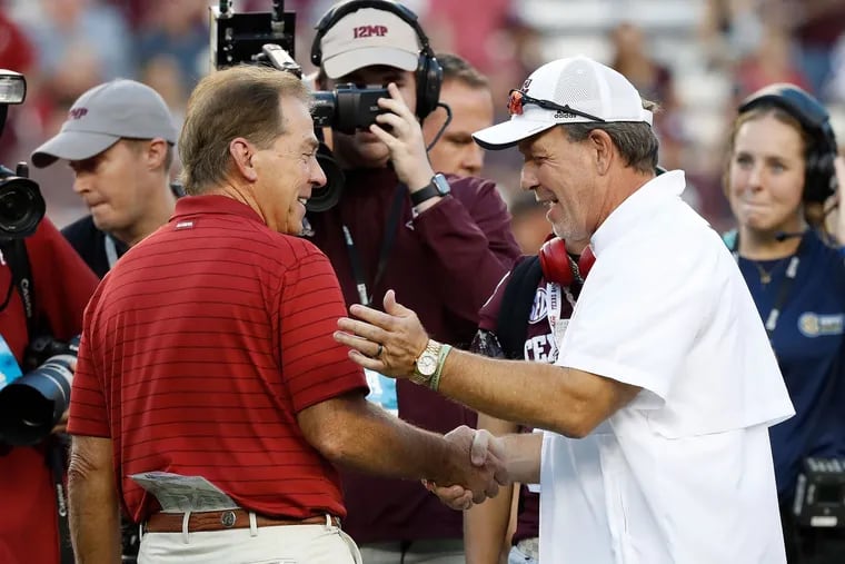 Coach Nick Saban (left) of the Alabama Crimson Tide  and coach Jimbo Fisher of the Texas A&M Aggies  meet before a game in October.