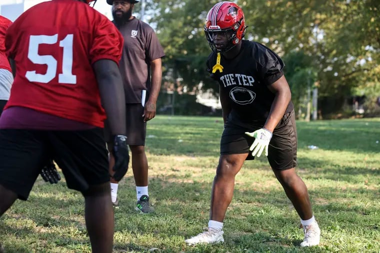 Defensive lineman Jahsear Whittington, right, runs drills during Imhotep football practice at Lonnie Young Recreation Center on Sept. 6.
