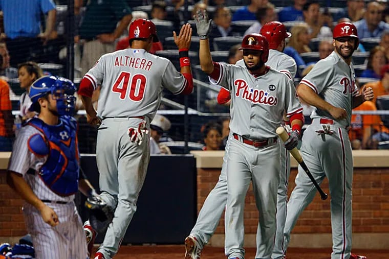 Philadelphia Phillies third baseman Andres Blanco (4) gives Philadelphia Phillies left fielder Aaron Altherr (40) a high five after scoring on home run by Philadelphia Phillies first baseman Darin Ruf (18) in the third inning against the New York Mets at Citi Field.
