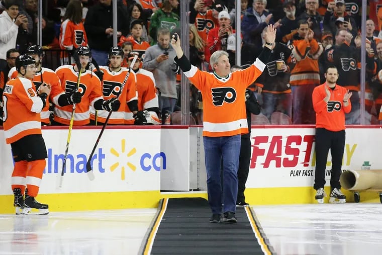 Eagles Head Coach Doug Pederson raises his arms before dropping the ceremonial first puck before the Flyers play the Tampa Bay Lightning on Thursday, January 25, 2018 in Philadelphia.