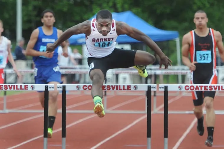 Wellington Zaza heads for victory in the District 1 boys' 300-meter hurdles. The senior also won the 110-meter hurdles and the triple jump. CURT HUDSON / For The Inquirer