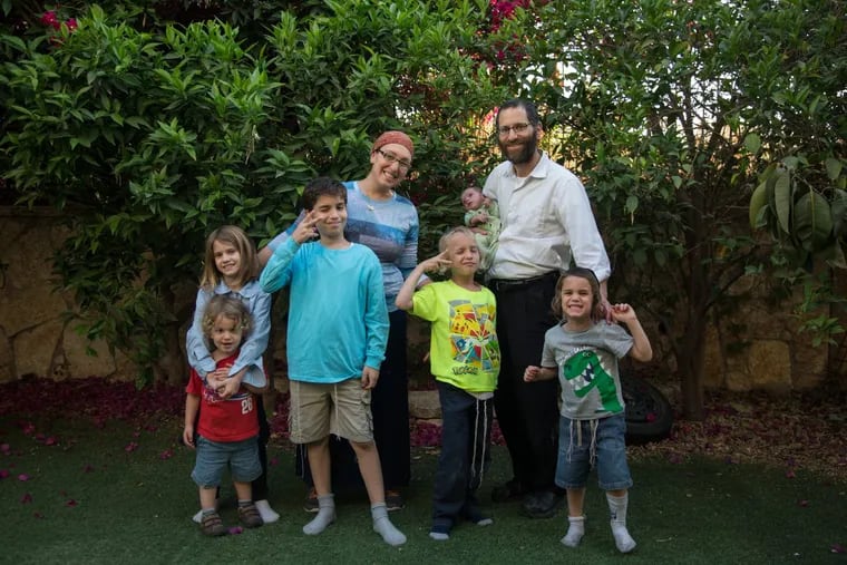 Lauren and Ira Somers in their backyard in Israel, with their children: From left, Uriel, 2; Riva, 9; Moshe, 10; Asher, 7; baby Ezra Dovid, born in April; and Yoel, 4.