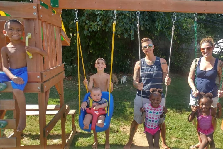 The Ponist clan, minus their current foster son (from left): Landon, DeAndre pushing Gavin in the baby swing, Alyx with Diane behind her, Kairah with Kristin behind her.