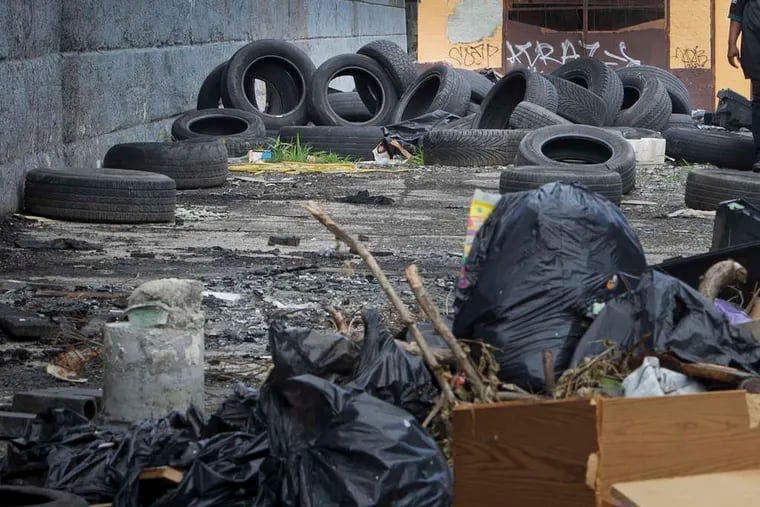 Tires and other rubbish pile up at an illegal dumping site near Emerald and Silver streets in Kensington. ALEJANDRO A. ALVAREZ / STAFF PHOTOGRAPHER