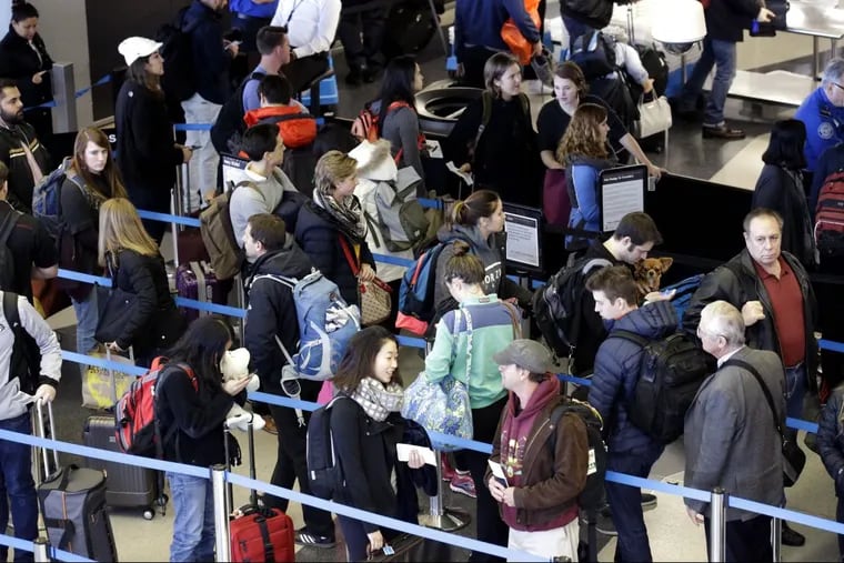 In this Nov. 29, 2015, file photo, travelers line up at a security checkpoint area in Terminal 3 at O'Hare International Airport in Chicago.