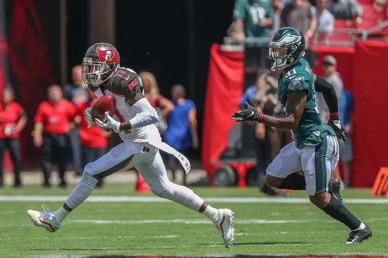 Tampa Bay's DeSean Jackson (left) beats Jalen Mills on the first play of the game for a touchdown.