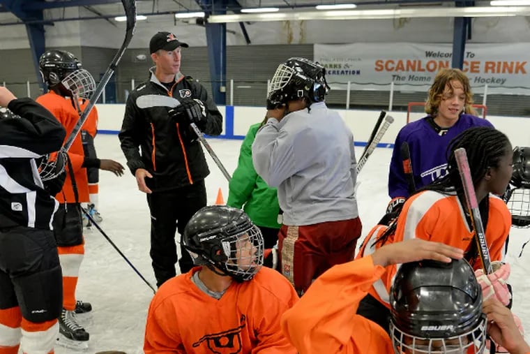Dave Hakstol talks about hockey with kids at the Scanlon Rec Center.