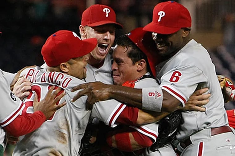 Roy Halladay was mobbed by his teammates after finishing off the Phillies' win over the Nationals. (Ron Cortes/Staff Photographer)