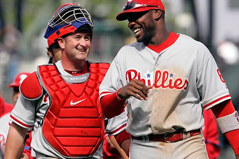 Philadelphia Phillies first baseman Ryan Howard, right, laughs with catcher Brian Schneider. (AP Photo/Eric Risberg)