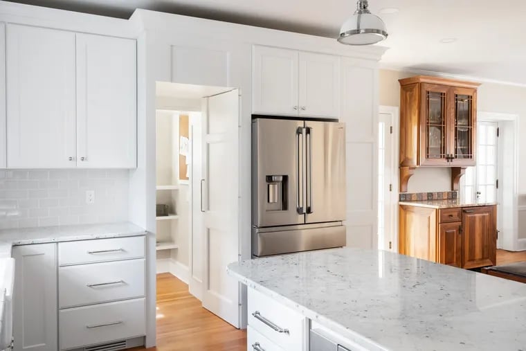 Inspired by the Ardmore Kitchen Tour, Susan Bruce and Neal Fitch hired Cottage Industries to redo their old kitchen. One of the many doors in the room now matches the cabinetry and opens to hidden pantry.