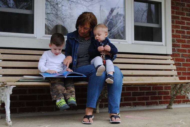 Christine Wilson shows her grandsons, Benjamin and Ethan Holodnak, “The Lorax” by Dr. Seuss.