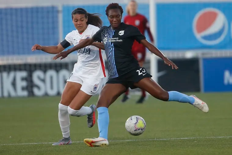 Sky Blue FC foward Ifeoma Onumonu (25) controlling the ball in front of OL Reign midfielder Shirley Cruz during the first half.