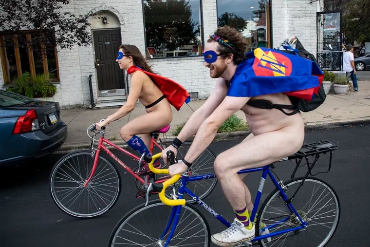 Will, 31, of Richmond, Va., is dressed up as "Wonder Wang," and his girlfriend, Polina, 26, of Fishtown Philadelphia, as "Thunder Puss," during the Philadelphia Naked Bike Ride on Saturday, Aug. 24, 2019.