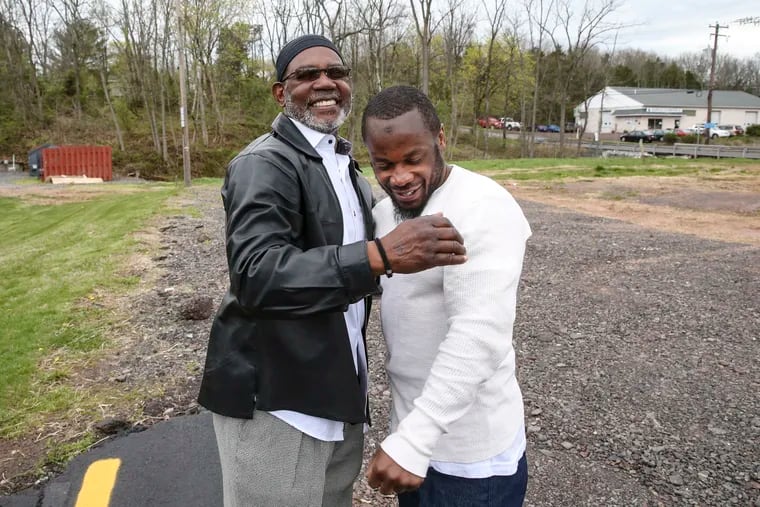 Collin Dixon, left, hugs his son Rafiq Dixon, who was released from prison on Thursday after his murder case was thrown out. Family members gathered to meet him and celebrate near State Correctional Institute Phoenix in Montgomery County.