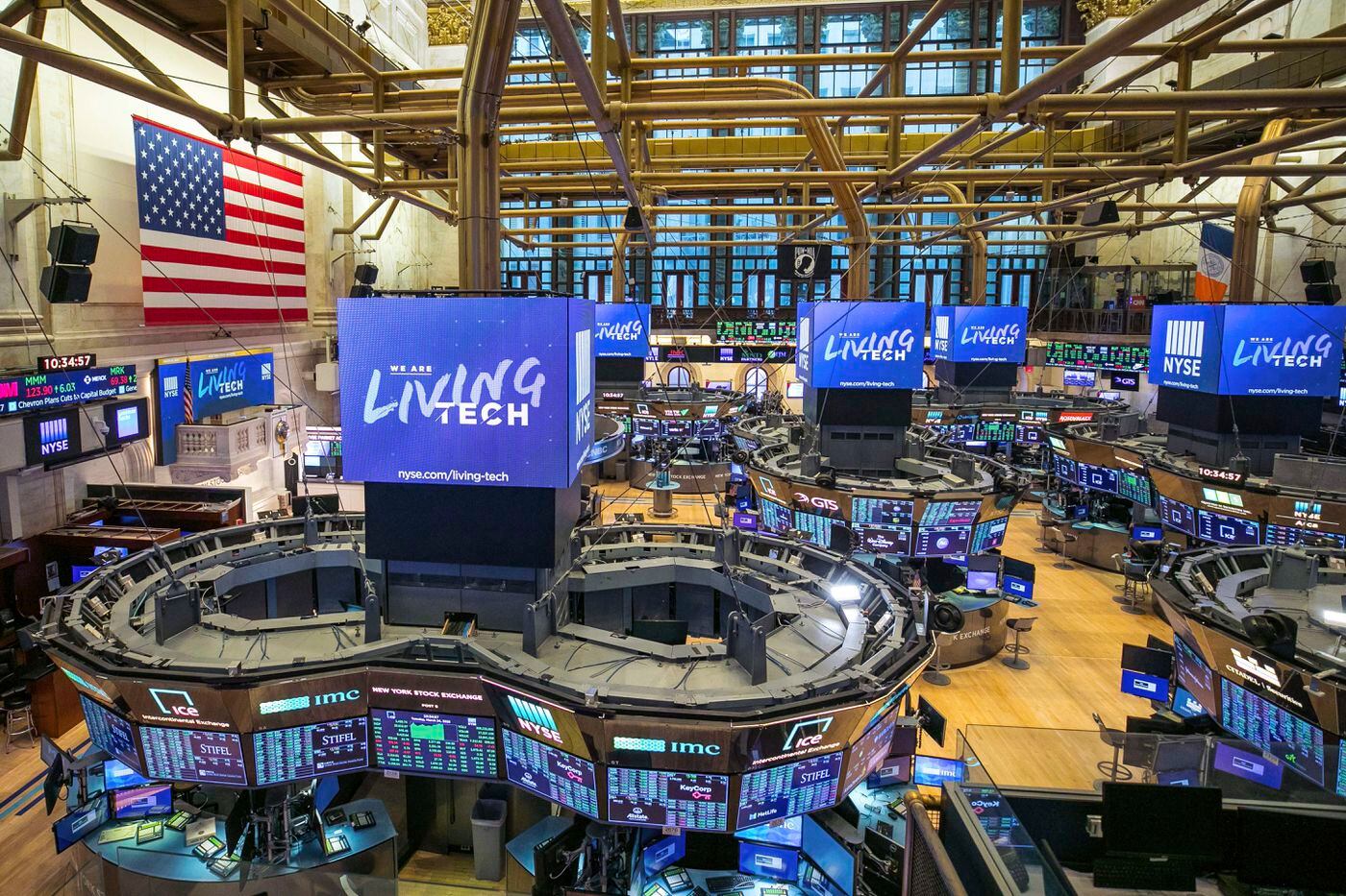 This photo provided by the New York Stock Exchange shows the unoccupied NYSE trading floor, closed temporarily for the first time in 228 years as a result of the Corona Virus, Tuesday March 24, 2020. (NYSE photo by Kearney Ferguson via AP)