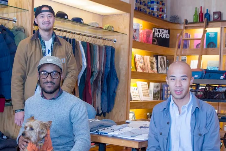 Ps&Qs co-founders Ky Cao (standing) and  Joe Lardizabal (right), with manager Saeed Ferguson. The menswear boutique, located on South Street, has a wide inventory of products and a big social media following. (Chanda Jones / Staff Photographer)