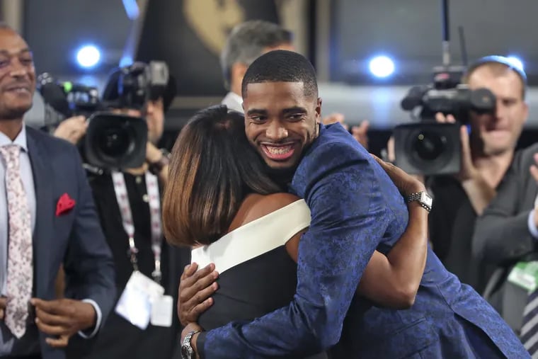 Villanova's  Mikal Bridges is greeted by friends and family after he was picked 10th overall by the Philadelphia 76ers during the first round of the NBA basketball draft in New York, Thursday, June 21, 2018.
