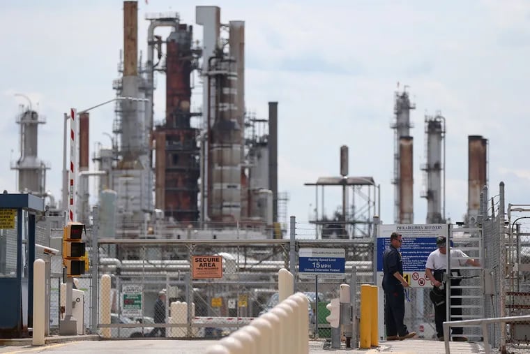 Workers enter the Philadelphia Energy Solutions refinery in South Philadelphia on Tuesday, Aug. 20, 2019. The company announced it is immediately laying off most of its workers at the refinery complex, which closed after a June explosion and fire.