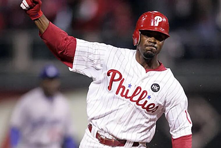 Jimmy Rollins pumps his fist after getting the game-winning hit in the ninth inning. (David Swanson/Staff Photographer)