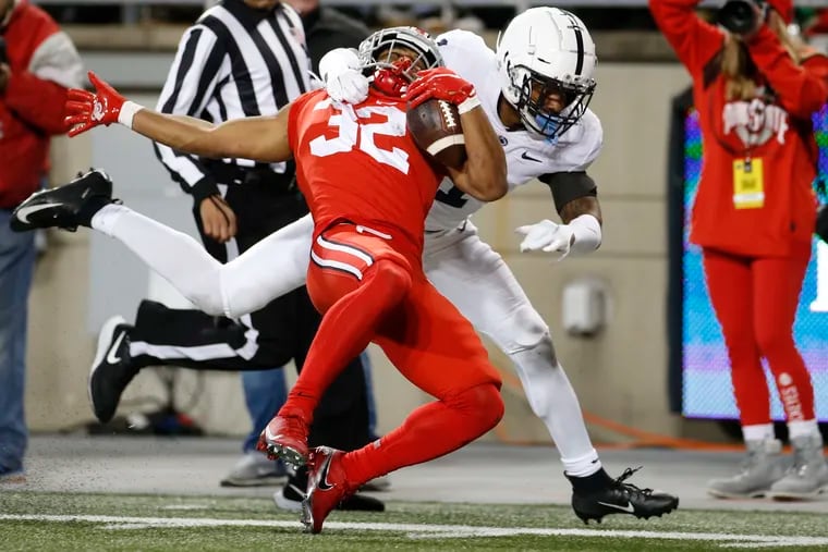 Penn State defensive back Jaquan Brisker, rear, tackles Ohio State running back TreVeyon Henderson during the second half on Saturday, Oct. 30, 2021, in Columbus, Ohio. Ohio State won, 33-24.