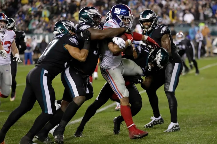 Giants running back Saquon Barkley surrounded by Eagles during a game on Dec. 9.