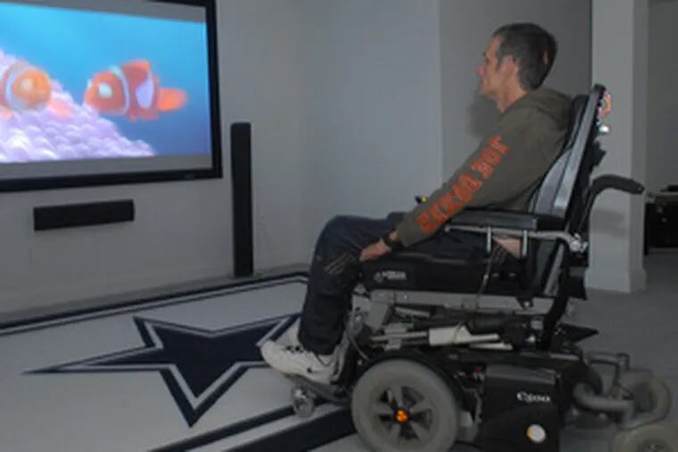Scott Haskell watches TV in his Coopersburg home. In a wheelchair after a workplace accident, he used an insurance settlement to build an automated dream house.