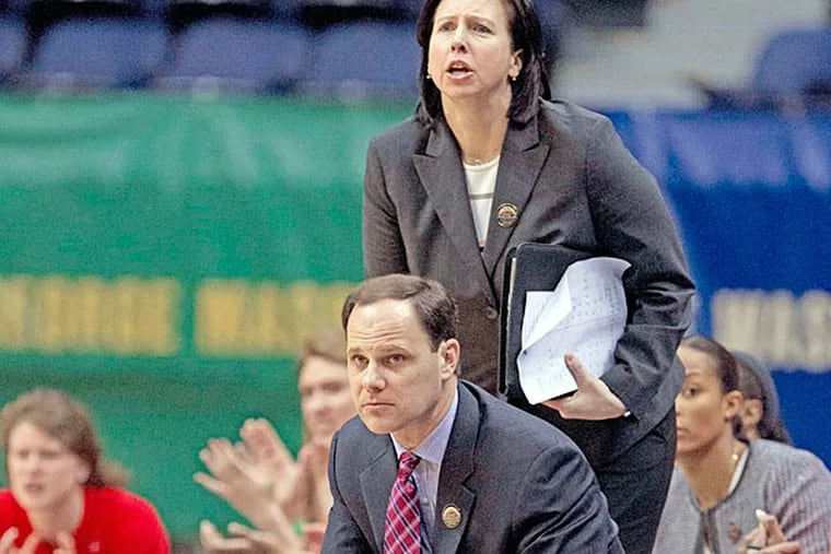 This March 6, 2014 photo provided by the University of Richmond shows women's basketball associate head coach Ginny Doyle, top, and head coach Michael Shafer during a game against VCU, in Richmond, Va. Doyle and director of basketball operations Natalie Lewis were two of the three people aboard a hot air balloon that drifted into a power line, burst into flames and crashed on Friday, May 9, 2014, in Virginia. Investigators say their remains were found about a mile apart in dense woods. (AP Photo/University of Richmond, Mitchell Leff)