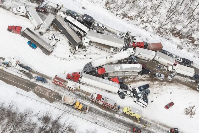 Vehicles pile up at the site of a fatal crash near Fredericksburg, Pa., Saturday, Feb. 13, 2016. The accident left tractor-trailers, box trucks and cars tangled together across several lanes of traffic and into the snow-covered median.