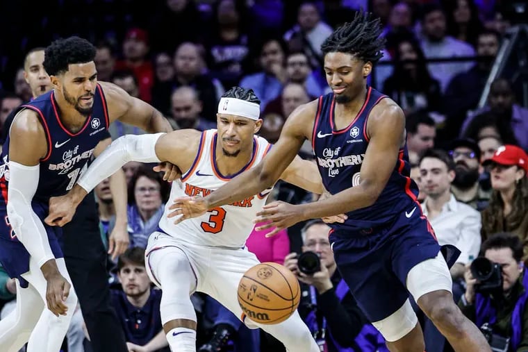 Tobias Harris and Tyrese Maxey battle with the Knicks' Josh Hart for the loose ball during their game in February.