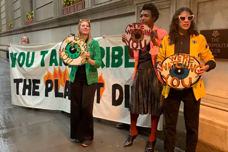 Protesters chanted, "You take bribes! The planet dies!" outside a Pennsylvania Manufacturers Association event in New York.