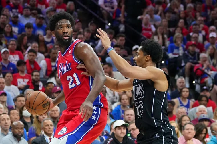 Philadelphia 76ers center Joel Embiid looks to make a move against Brooklyn Nets point guard Spencer Dinwiddie during the 76ers’ 121-101 victory in Game 1 of the Eastern Conference playoffs Saturday. Philadelphia is a double-digit favorite in Game 2 on Monday. (Photo by Mitchell Leff/Getty Images)