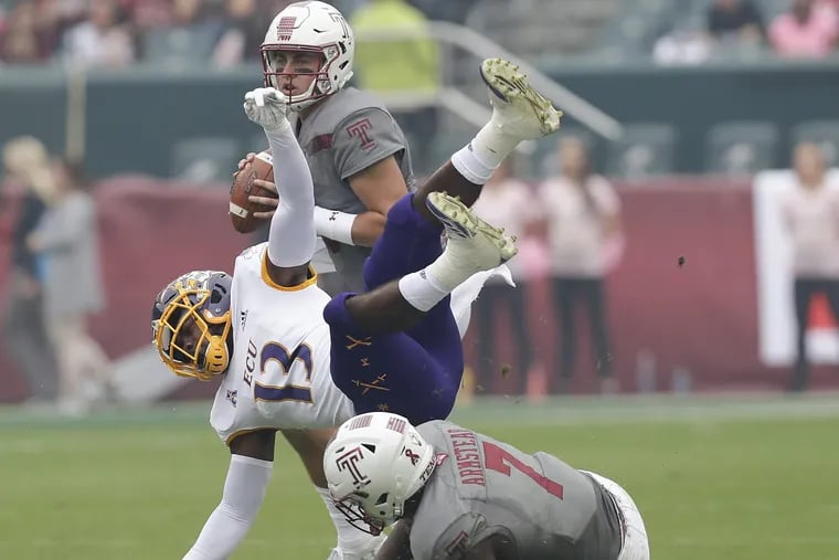 East Carolina defensive back Davondre Robinson gets blocked by Temple running back Ryquell Armstead as quarterback Anthony Russo holds the football in the first-quarter on Saturday, October 6, 2018. YONG KIM / Staff Photographer