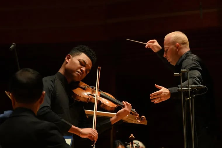 Violinist Randall Goosby performing one of Florence Price's works with the Philadelphia Orchestra, Yannick Nezet-Seguin is conducting.