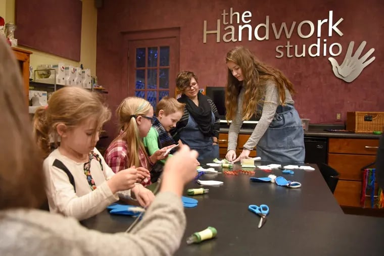 Teachers Stephanie Vance (rear, left) and Sharon Baranov (rear, right) work with girls and boys at The Handwork Studio in Narberth.