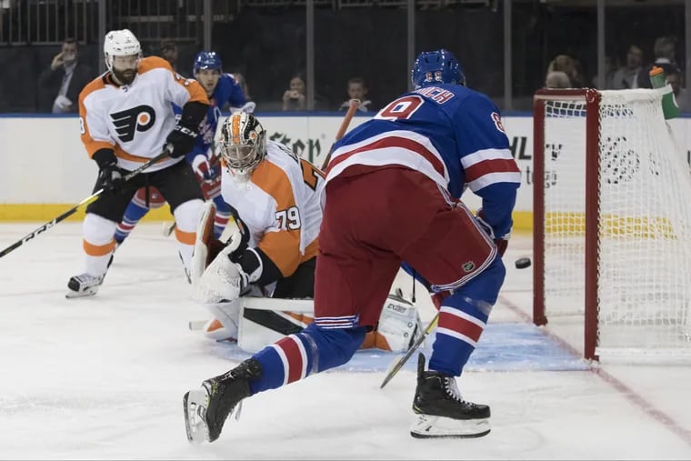 The Rangers' Pavel Buchnevich redirects a shot past Flyers goalie Carter Hart, who played well in his two-period stint Wednesday.