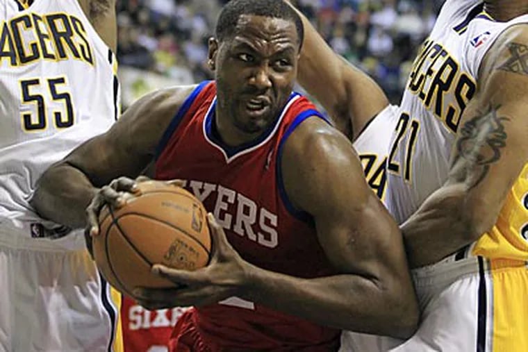 Elton Brand grabs a rebound from the Pacers' Roy Hibbert and David West during the first half. (Darron Cummings/AP)