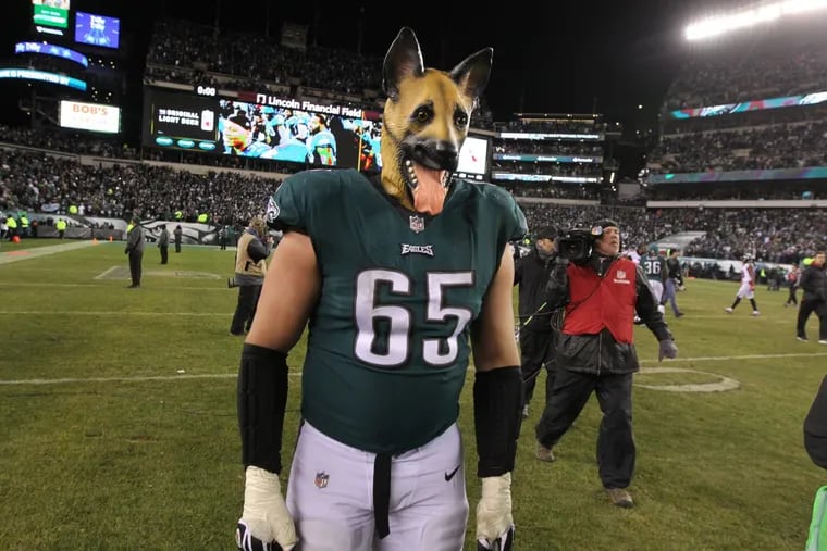 Eagles tackle Lane Johnson wearing a dog mask as he walks off the field after the Eagles defeated the Falcons in the divisional round.