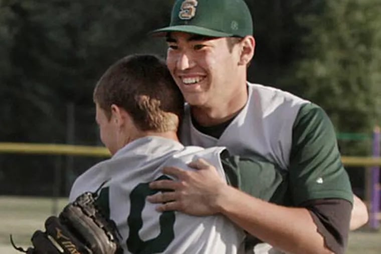 Seneca pitcher Kevin Comer is hugged by teammate Ty Lyons after winning the Group
3 final. (Elizabeth Robertson/Staff Photographer)