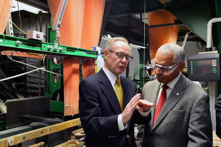 Near a shuttle loom, Bally Ribbon Mills chief Ray Harries (left) talks with NASA Administrator Charles Bolden. The firm is weaving NASA a thermal pad from quartz fiber.