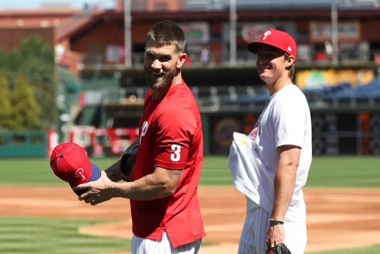 Bryce Harper with teammate Mickey Moniak before the Phillies' season-opener against the Athletics on Friday.