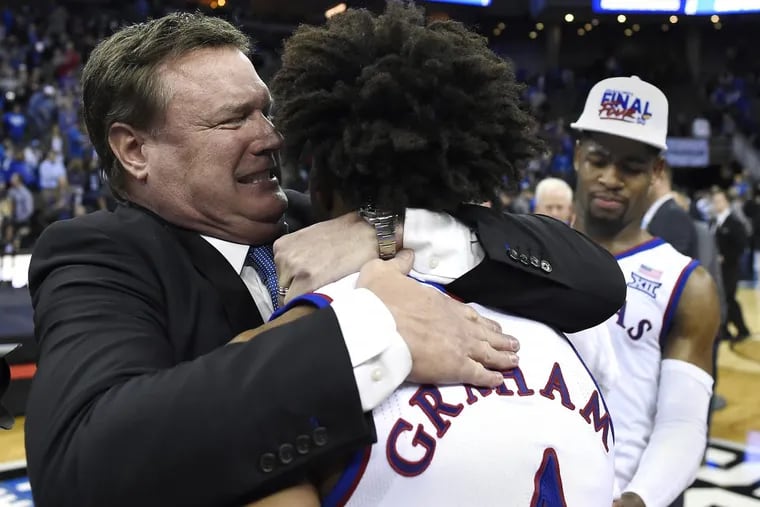 Kansas coach Bill Self embraces senior guard Devonte’ Graham after the Jayhawks took down Duke and earned a trip to the Final Four in San Antonio on Sunday in Omaha, Neb.
