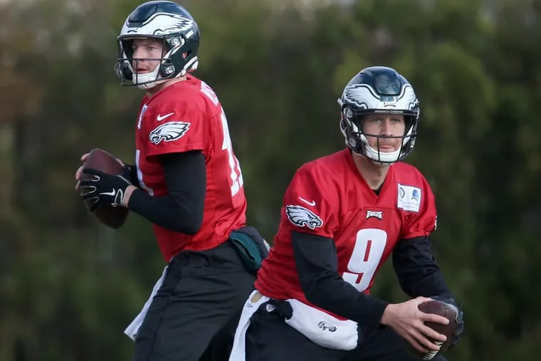 Eagles quarterbacks Nick Foles (9) and Carson Wentz (11) throw passes during practice at the NovaCare Complex in South Philadelphia on Thursday, Nov. 29, 2018.